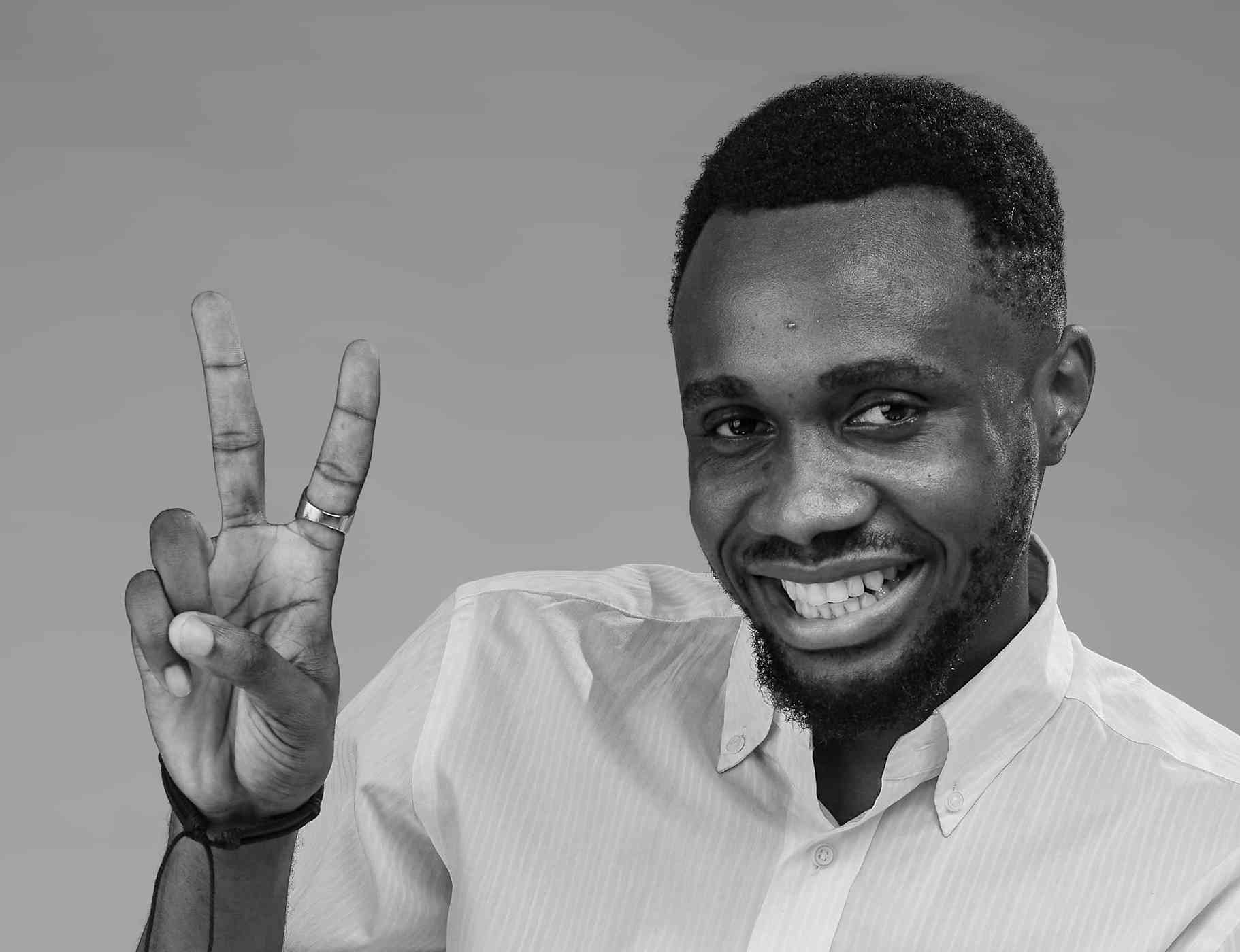 A monochrome version of the previous joyful portrait, this black-and-white image enhances the subject’s expression and gesture with classic simplicity and timelessness.